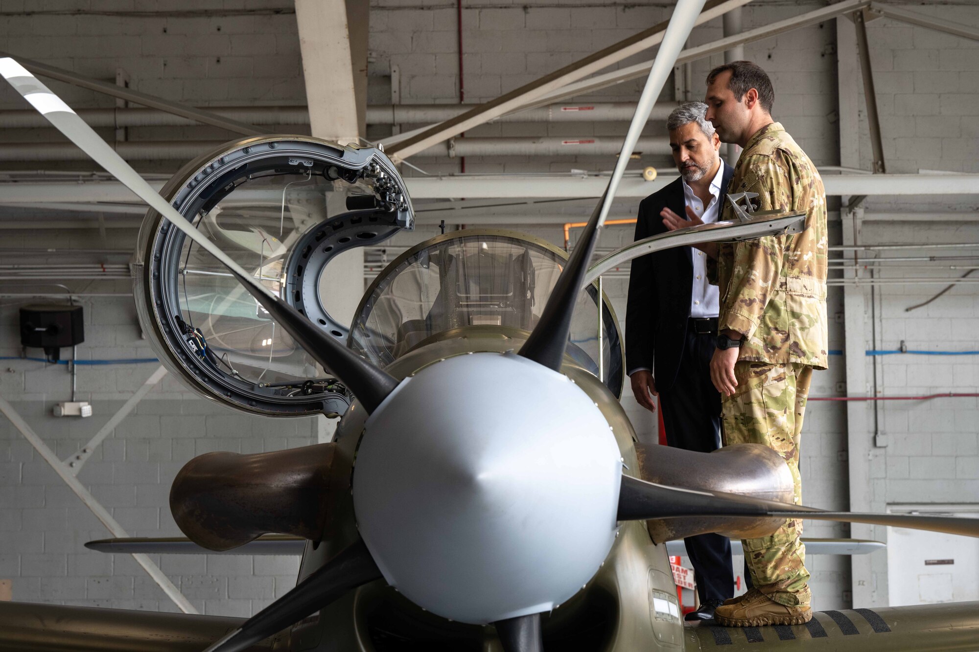 President Mario Abdo Benítez of the Republic of Paraguay views a A-29 display while an AFSOC Airman with the 18th Special Operations Test and Evaluation Squadron explains the aircraft’s mission at Hurlburt Field, Fla., March 31, 2023.