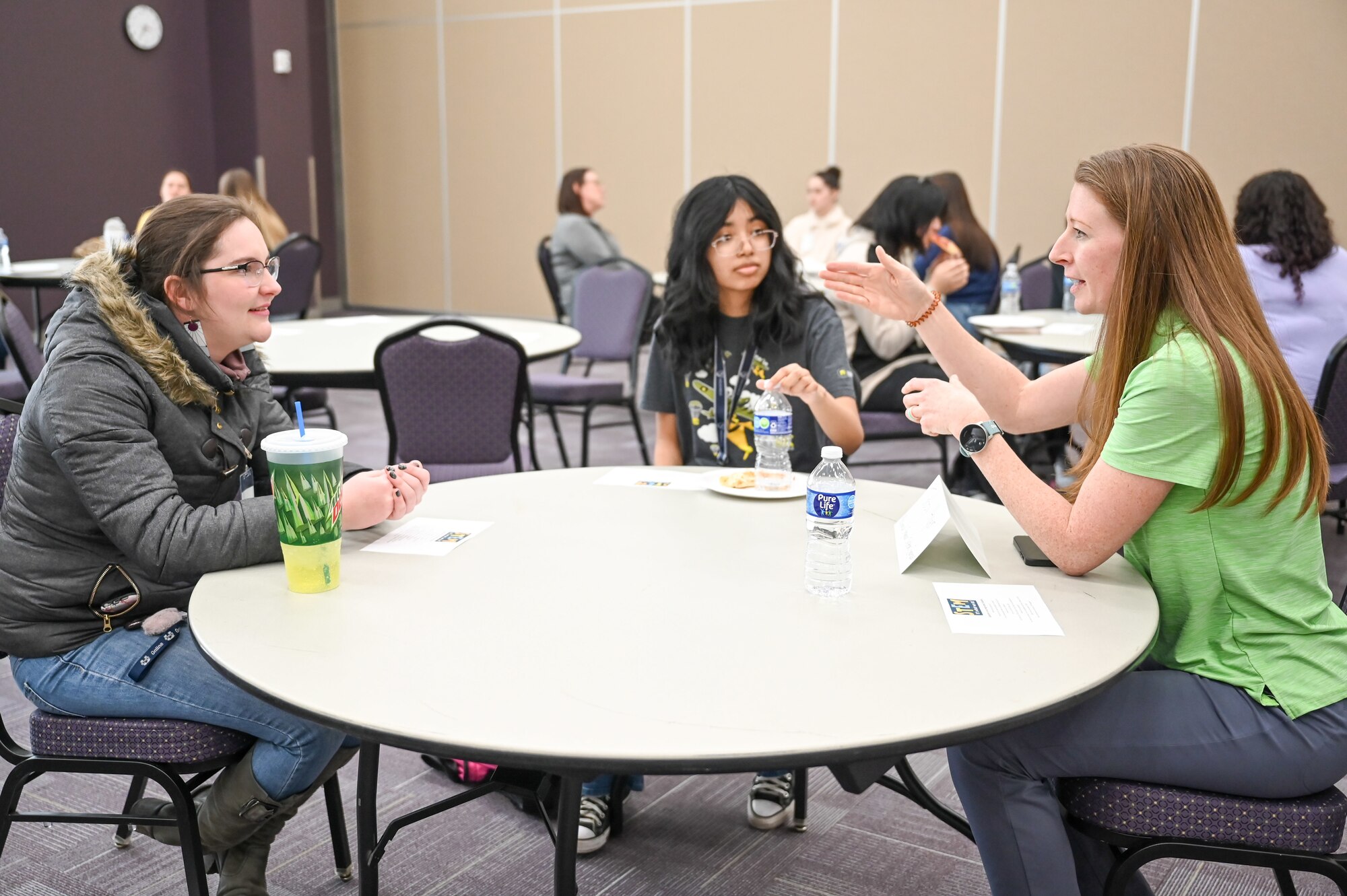 Tabby Hyer, a systems engineer at Air Force Lifecycle Management Center at Hill Air Force Base, Utah, meets with female high school students from NUAMES High School in Layton, during a Science, Technology, Engineering and Math (STEM) event March 30, 2023.
