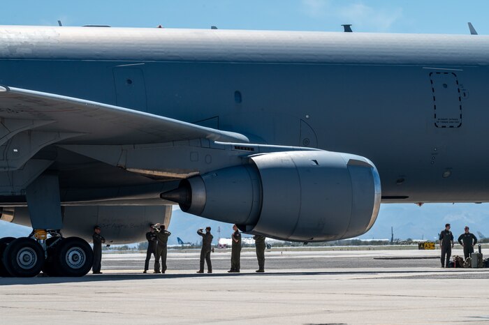 Prior to takeoff, the crew stands outside of the KC-10A and sign their autograph on the underside as part of a tradition.