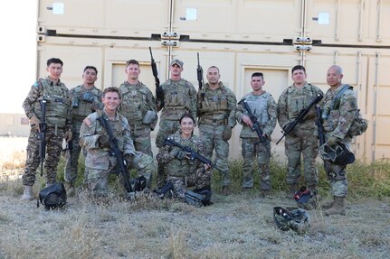 Arizona National Guard members and two soldiers from the Republic of Kazakhstan after completing the mystery event during the Arizona Best Warrior Competition in Florence, Arizona, April 25, 2023.