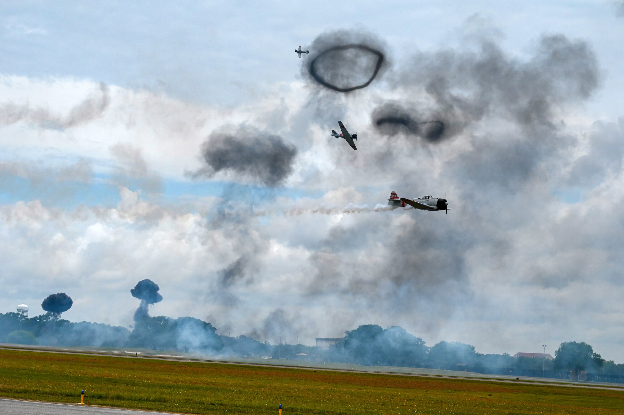 Aircraft from Commemorative Air Force perform a reenactment of a World War II bomb drop during the 2023 Thunder Over the Sound Air and Space Show on Keesler Air Force Base, Mississippi, April 29, 2023.
