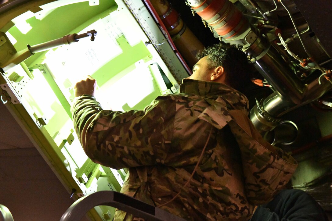 U.S. Air Force Master Sgt. Jeremy Green, a 749th Aircraft Maintenance Squadron aircraft electrical environmental specialist from Travis Air Force Base, Calif., installs a new wire harness in an auxiliary power unit of a KC-46 Pegasus at Altus Air Force Base, Oklahoma, Feb. 24, 2023. Electrical environmental specialists are responsible for maintaining and repairing electrical components on the aircraft. (U.S. Air Force photo by Airman 1st Class Miyah Gray)