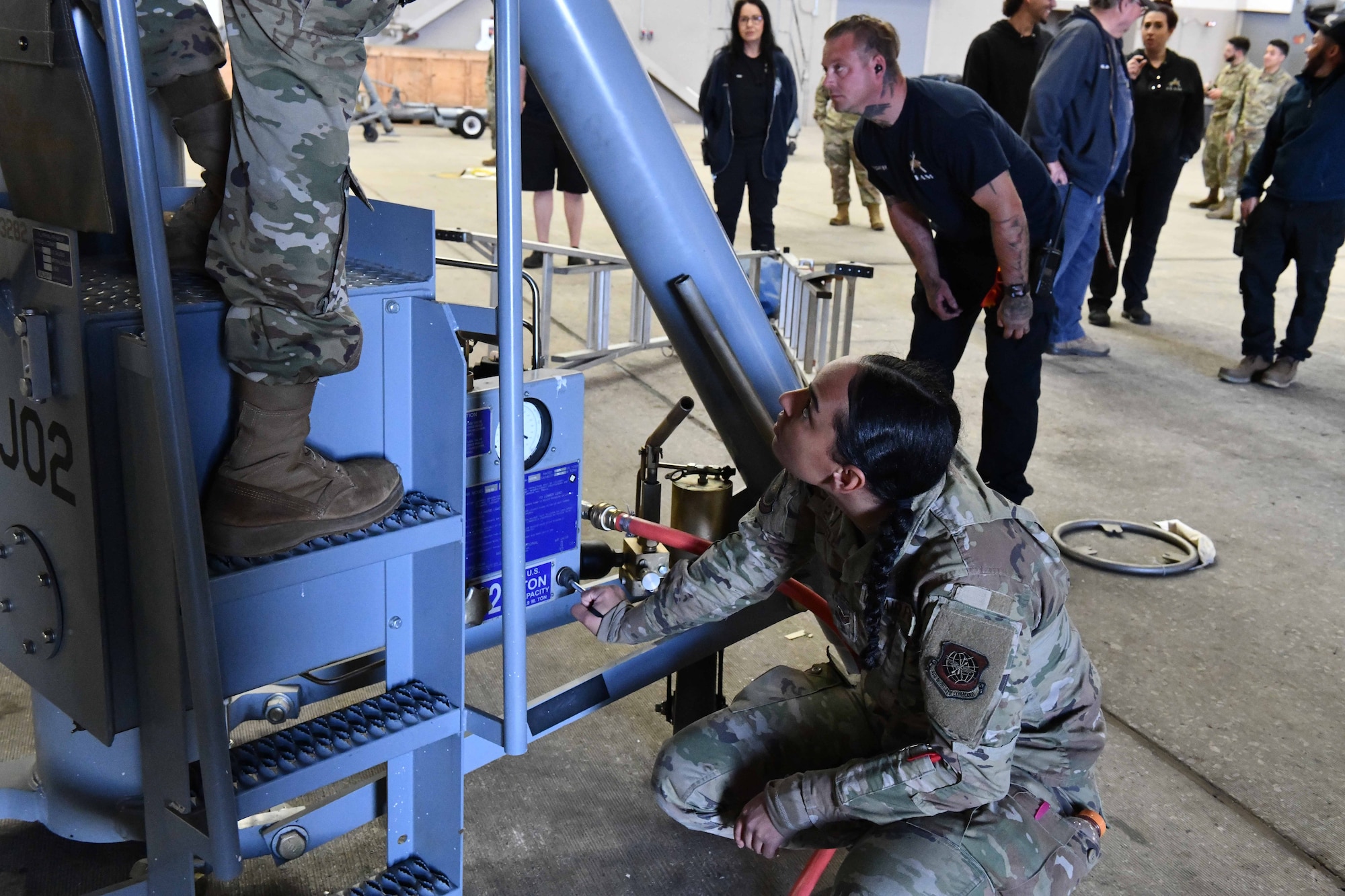 U.S. Air Force Senior Airman Raiven Belisle, a 660th Aircraft Maintenance Squadron KC-10 Extender crew chief from Travis Air Force Base, Calif., operates a KC-46 aircraft jack at Altus Air Force Base, Oklahoma, April 18, 2023. The jack works through an air pump mechanism to propel the plane up. (U.S. Air Force photo by Airman 1st Class Miyah Gray)