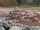 Excavators sort soil and material into multiple piles
