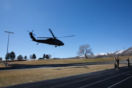 A UH-60 Black Hawk helicopter flown by members of the Utah National Guard’s 2nd General Support Aviation Battalion, 211th Aviation Regiment leaves Camp Williams, Utah with high school principals, counselors, teachers, and administrators to learn more about the Utah National Guard and what it has to offer their students.