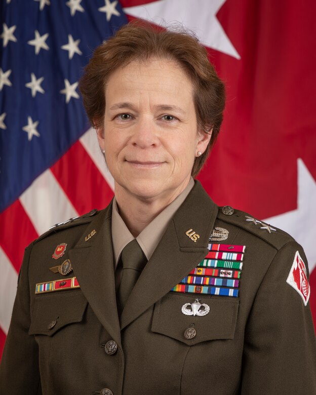 Photo of lady in military uniform in front of the U.S. flag