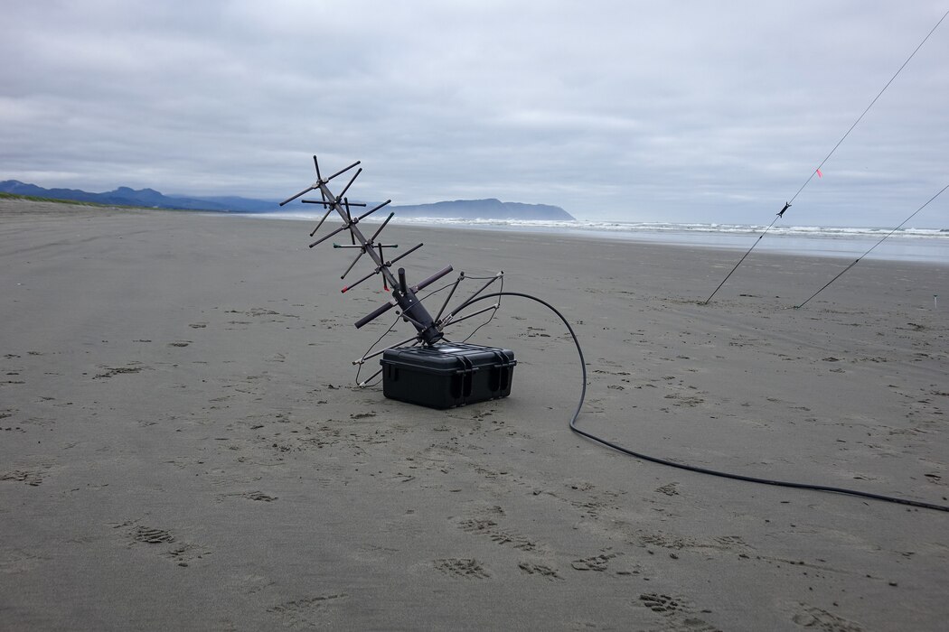Setting up communication equipment on an Oregon beach