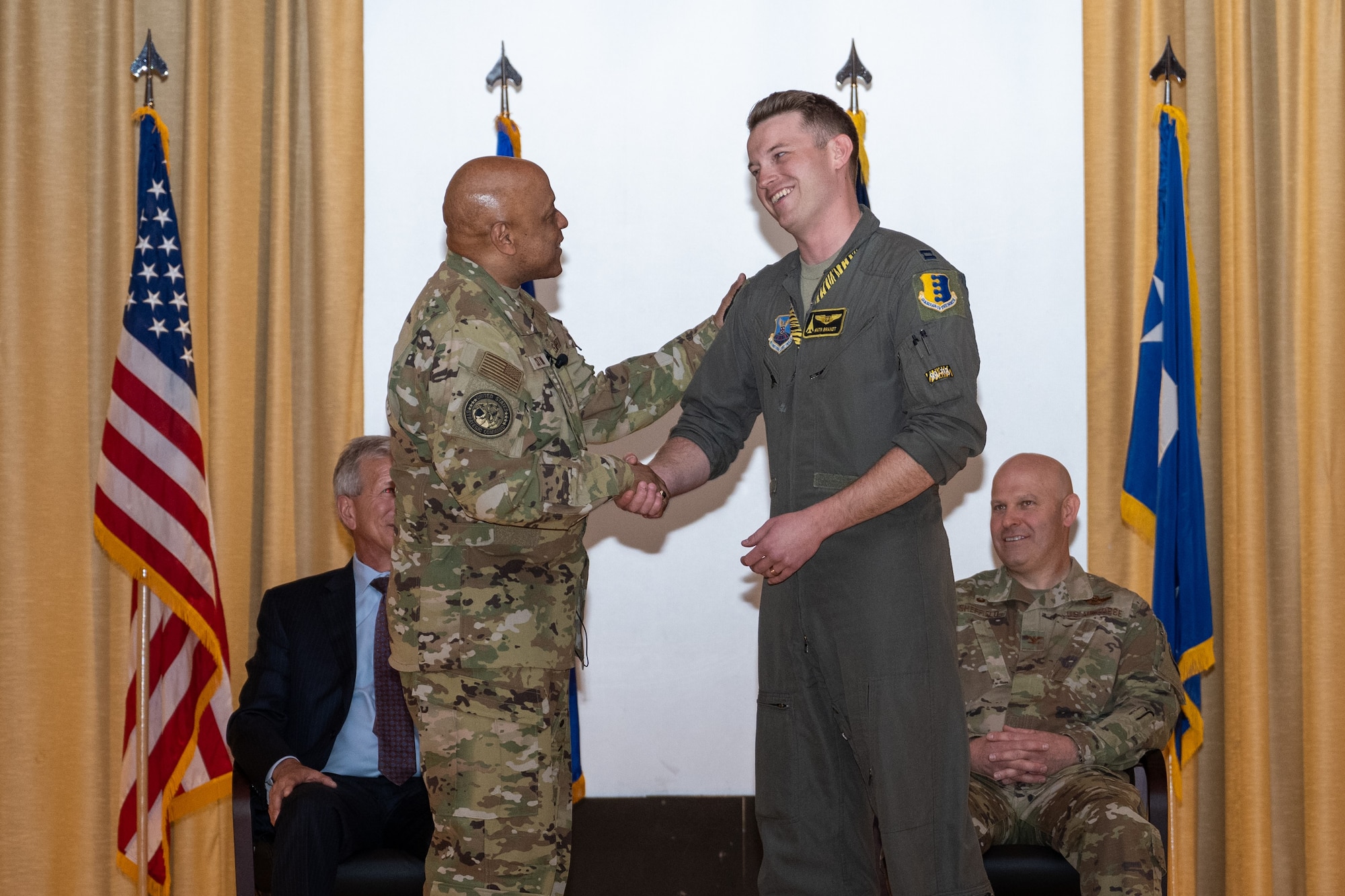 Gen. Anthony Cotton, U.S. Strategic Command commander, coins Capt. Clint Brandt, 37th Bomb Squadron training flight commander, during an all-call on at Ellsworth Air Force Base, South Dakota, April 21, 2023. Brandt served as lead project officer for the 37th BS’ Bomber Task Force mission to the Indo-Pacific Region from Oct. to Nov. 2022, ensuring the effective beddown  of four B-1B Lancers and 221 personnel. (U.S. Air Force photo by Senior Airman Alexis M. Morris)