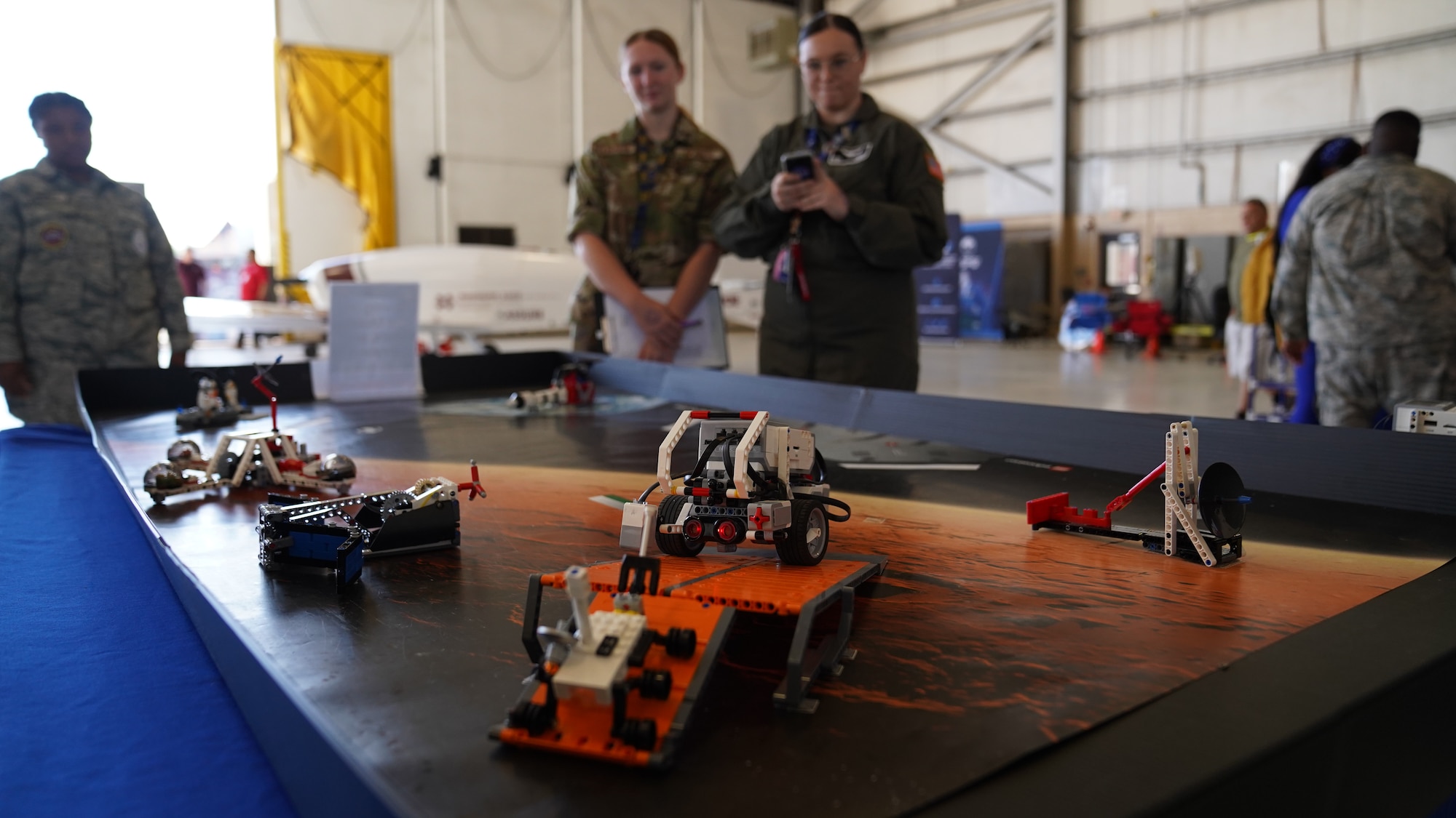 Remote controlled miniature space vehicles are displayed at the NASA table in the STEM Expo at Hangar 4 on Keesler Air Force Base, Mississippi, April 28, 2023.