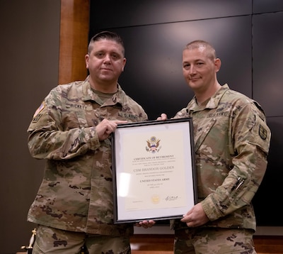 Illinois Army National Guard Command Sgt. Maj. Brandon Golden, Commandant of the 129th Regiment (Regional Training Institute), receives the Certificate of Retirement presented by Lt. Col. Wyatt Bickett, deputy Commander, 129th Regiment, during a retirement ceremony at the Illinois Military Academy, Camp Lincoln, Springfield, Illinois, April 23.