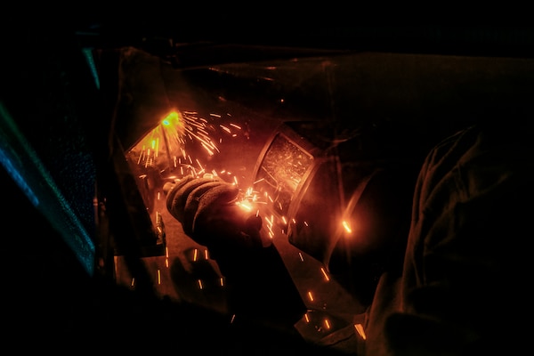 A Joint Task Force-Red Hill (JTF-RH) contractor uses a stick weld on a support beam during repairs at the Red Hill Bulk Fuel Storage Facility (RHBFSF) in Halawa, Hawaii, April 25, 2023. JTF-RH is in phase three of its five-phase defueling plan. Personnel are focused on completing repairs, quality control tasks, training, response preparation, the National Environmental Policy Act Environmental Assessment, regulatory approvals and operational planning for all major milestones. This extensive preparatory work will help ensure the safe and expeditious defueling of the RHBFSF. (U.S. Navy photo by Mass Communication Specialist 2nd Class James Finney)