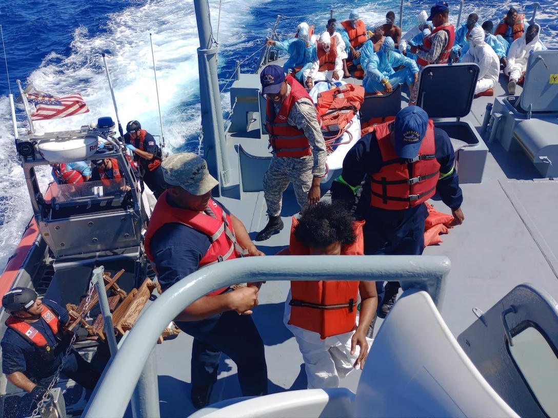 Coast Guard Cutter Winslow Griesser returns 37 of 41 migrants to a Dominican Republic Navy vessel April 29, 2023.  The migrant group was interdicted by the Coast Guard Cutter Richard Dixon in Mona Passage waters north of Desecheo, Puerto Rico April 27, 2023.  (Courtesy photo)