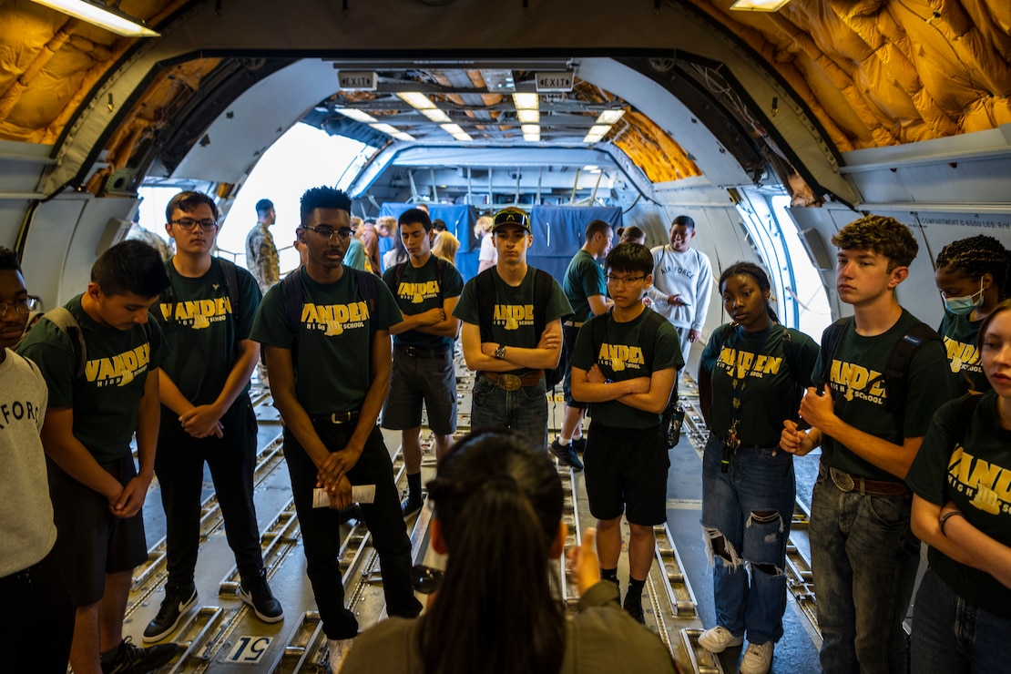 Highschoolers listen to a briefing inside an aircraft during a Project Tuskegee, Aviation Inspiration Mentorship event at Travis Air Force Base, California, April 28, 2023. More than 400 students from the surrounding schools and universities attended an aviation-focused event with opportunities to learn from Airmen and discuss career prospects as well as tour a B-1B from Ellsworth AFB and a C-5M Super Galaxy, C-17 Globemaster III and KC-10 Extender from Travis AFB. (U.S. Air Force photo by Nicholas Pilch)