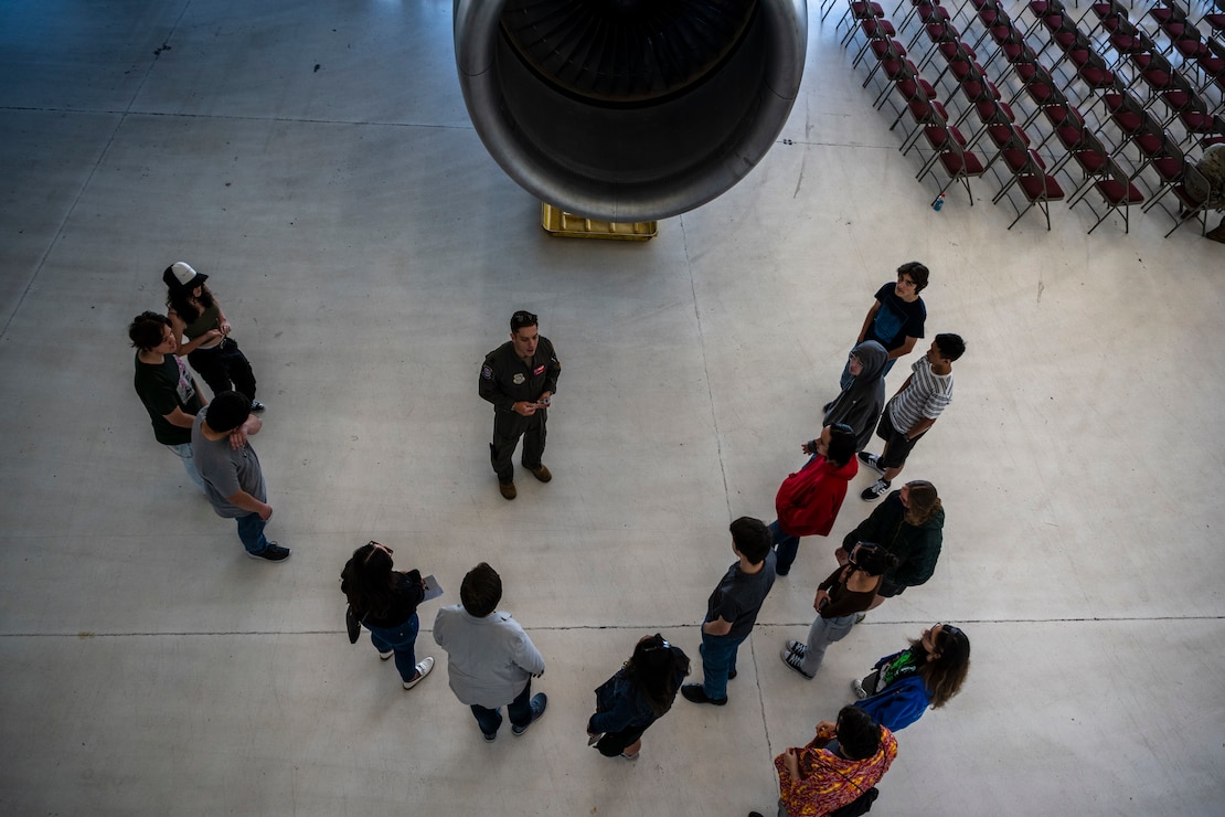 Students speak with a member of the Project Tuskegee team during a Project Tuskegee, Aviation Inspiration Mentorship event at Travis Air Force Base, California, April 28, 2023. More than 400 students from the surrounding schools and universities attended an aviation-focused event with opportunities to learn from Airmen and discuss career prospects as well as tour a B-1B from Ellsworth AFB and a C-5M Super Galaxy, C-17 Globemaster III and KC-10 Extender from Travis AFB. (U.S. Air Force photo by Nicholas Pilch)