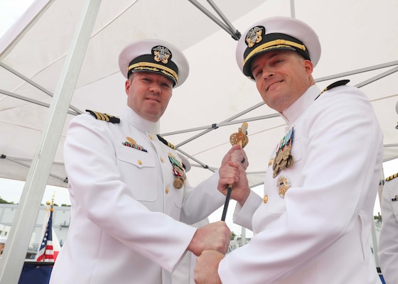Cmdr. Matthew Hays hands off Capt. Paul Milius’ saber to Cmdr. Leif Gunderson during a change-of-command ceremony aboard the Arleigh Burke-class guided missile destroyer USS Milius (DDG 69). During the ceremony, Hays was relieved as Milius’ commanding officer by Gunderson. Milius is assigned to Commander, Task Force 71/Destroyer Squadron (DESRON) 15, the Navy’s largest forward-deployed DESRON and the U.S. 7th Fleet’s principal surface force.