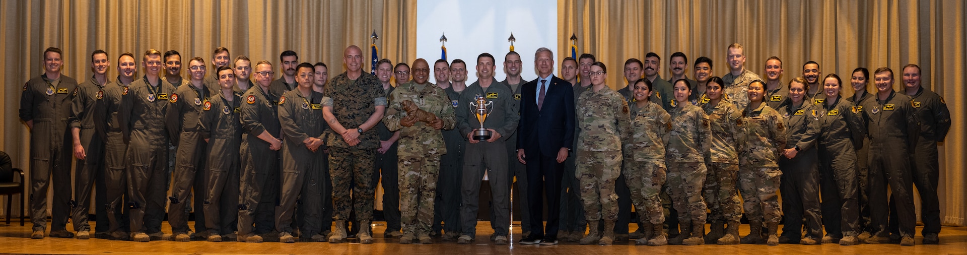 Gen. Anthony Cotton, United States Strategic Command commander, and Mr. Lance Fritz, Strategic Command Consultation Committee member, pose for a photo with the 37th Bomb Squadron after presenting the Omaha Trophy at Ellsworth Air Force Base, South Dakota, April 21, 2023. The 37th BS is one of the oldest squadrons in the United States Air Force and famously flew the Doolittle Raid in WWII.  (U.S. Air Force photo by Senior Airman Alexis M. Morris)