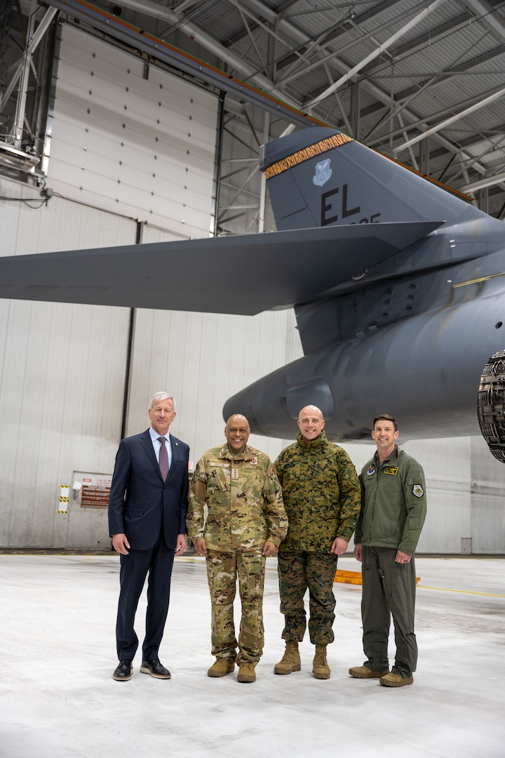 Mr. Lance Fritz, Strategic Command Consultation Committee member, far left , Gen. Anthony Cotton, U.S. Strategic Command commander, Sgt. Maj. Howard Kreamer, USSTRATCOM command senior enlisted leader, and Lt. Col. Christopher McConnell, 37th Bomb Squadron commander,, far right, pose for a photo in front of a B-1B Lancer on at Ellsworth Air Force Base, South Dakota, April 21, 2023. Senior USSTRATCOM and the Strategic Command Consultation Committee leaders traveled to Ellsworth to present the 37th BS with the prestigious Omaha Trophy, presented to only four USSTRATCOM units annually. (U.S. Air Force photo by Senior Airman Alexis M. Morris)