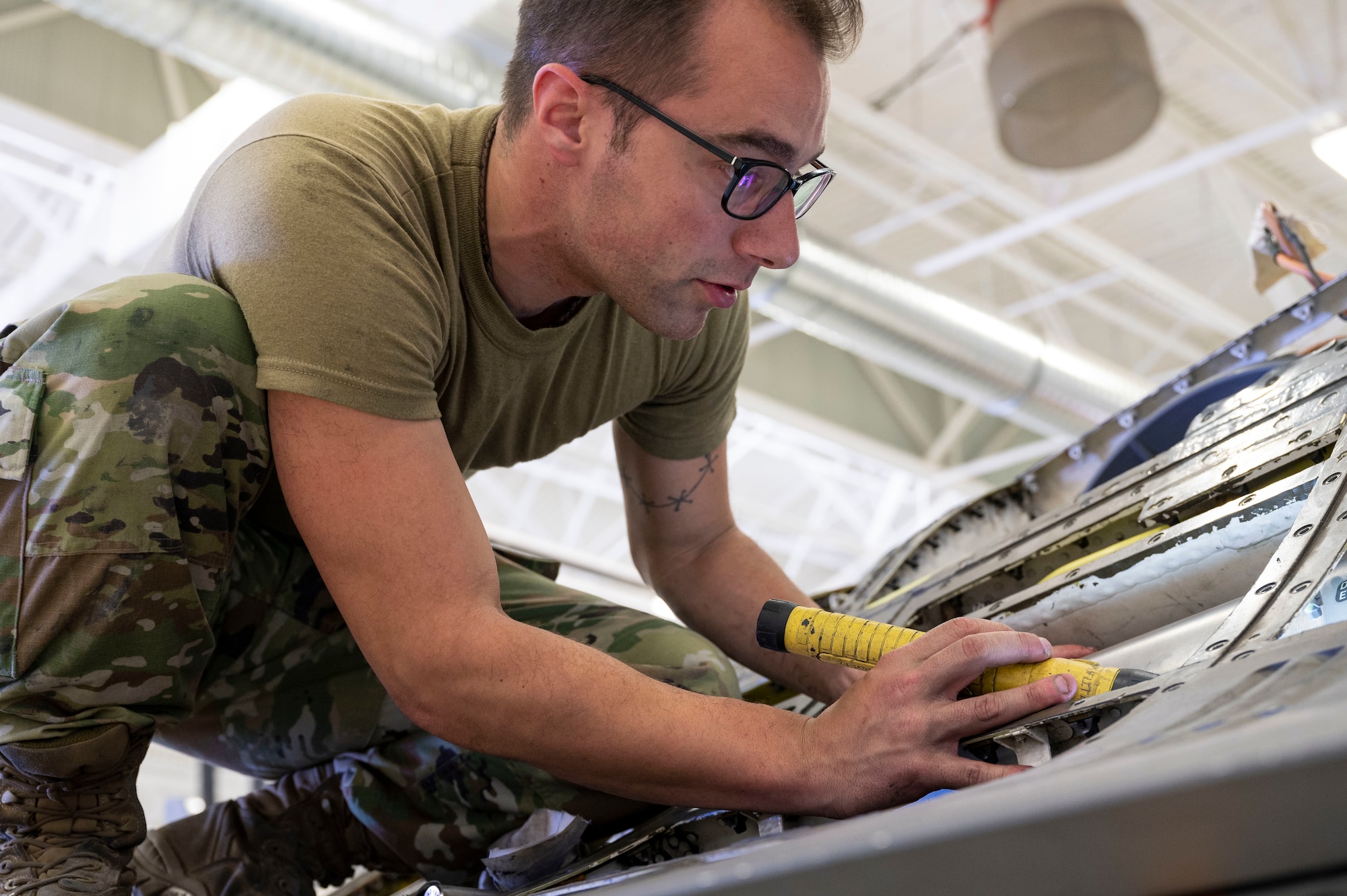 U.S. Air Force Staff Sgt. David Sterling, 49th Component Maintenance Squadron aircraft fuels systems craftsman, inspects a fuel tank at Holloman Air Force Base, New Mexico, April 26, 2023.