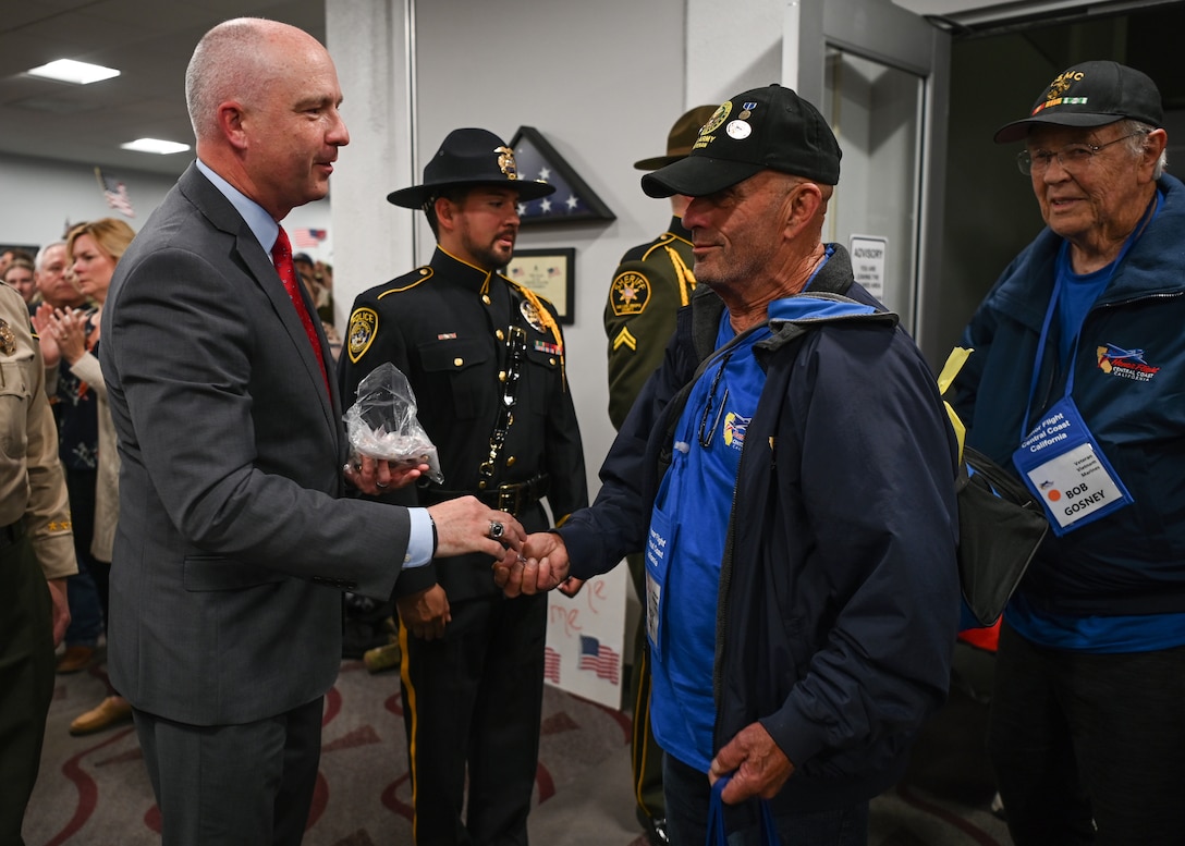 Dan Dow, San Luis Obispo County district attorney greets the veterans during their arrival to the Santa Maria Airport in Santa Maria, Calif., April 26, 2023. Over 1,000 attendees showed support at the event including family members, friends, military personnel and local residents. (U.S. Space Force photo by Senior Airman Tiarra Sibley)