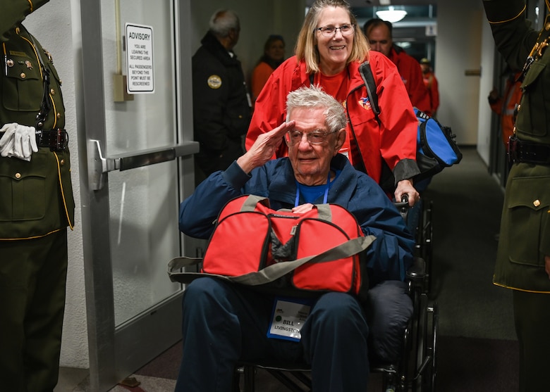 A WWII Army veteran of the California Central Coast Coastal Honor Flight salutes service members during his arrival to the Santa Maria Airport in Santa Maria, Calif., April 26, 2023. Over 1,000 attendees showed support at the event including family members, friends, military personnel and local residents. (U.S. Space Force photo by Senior Airman Tiarra Sibley)