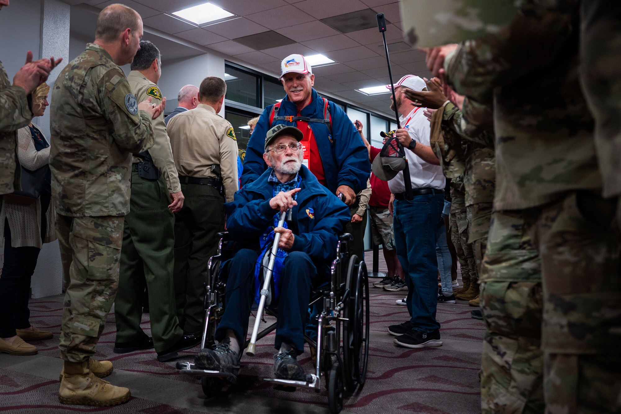 A veteran of the California Central Coast Coastal Honor Flight greets service members during his arrival to the Santa Maria Airport in Santa Maria, Calif., April 26, 2023. More than 1,000 attendees showed up to support the event including family members, friends, military personnel and local residents. (U.S. Space Force photo by Tech. Sgt. Luke Kitterman)