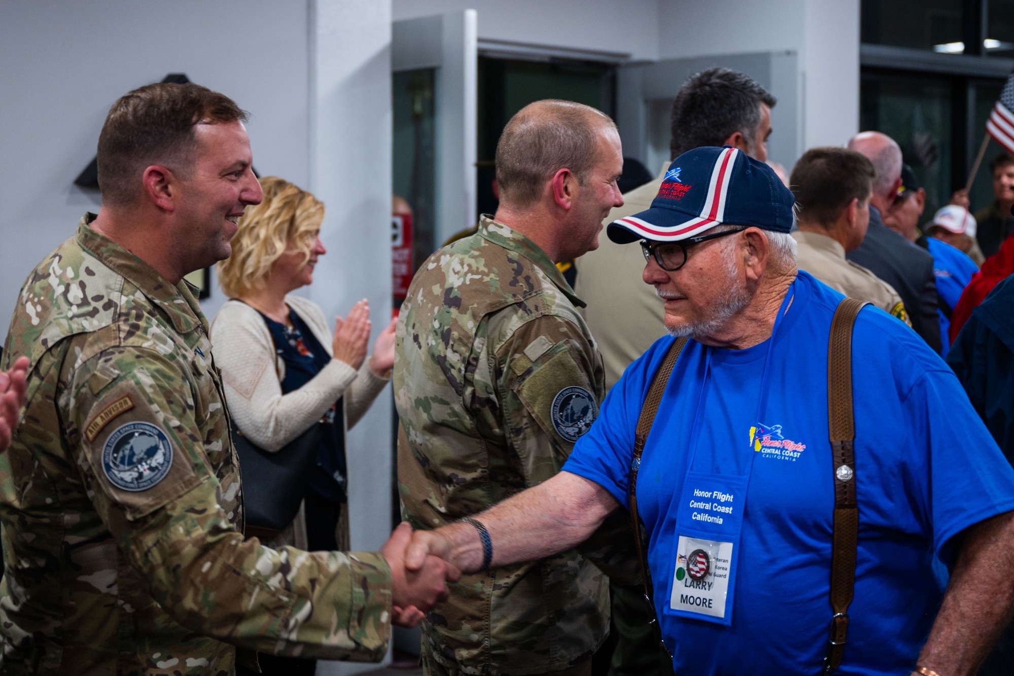 U.S. Space Force Chief Master Sgt. Grange S. Coffin, Combined Force Space Component Command senior enlisted leader, left, shakes the hand of a veteran during the arrival of the California Central Coast Coastal Honor Flight at the Santa Maria Airport in Santa Maria, Calif., April 26, 2023. More than 1,000 attendees showed up to support the event including family members, friends, military personnel and local residents. (U.S. Space Force photo by Tech. Sgt. Luke Kitterman)
