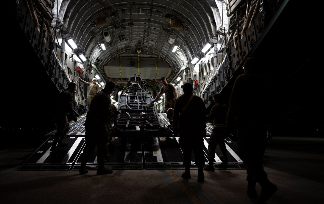 U.S. Airmen, assigned to the 28th Bomb Wing and the 15th Wing, load cargo onto a C-17  Globemaster III at Ellsworth Air Force Base, South Dakota during a partner integration mission in support of Exercise COPE INDIA 23, April 6, 2023. U.S. Indo-Pacific Command is committed to a free and open Indo-Pacific. (U.S. Air Force Photo by Airman 1st Class Yendi Borjas)