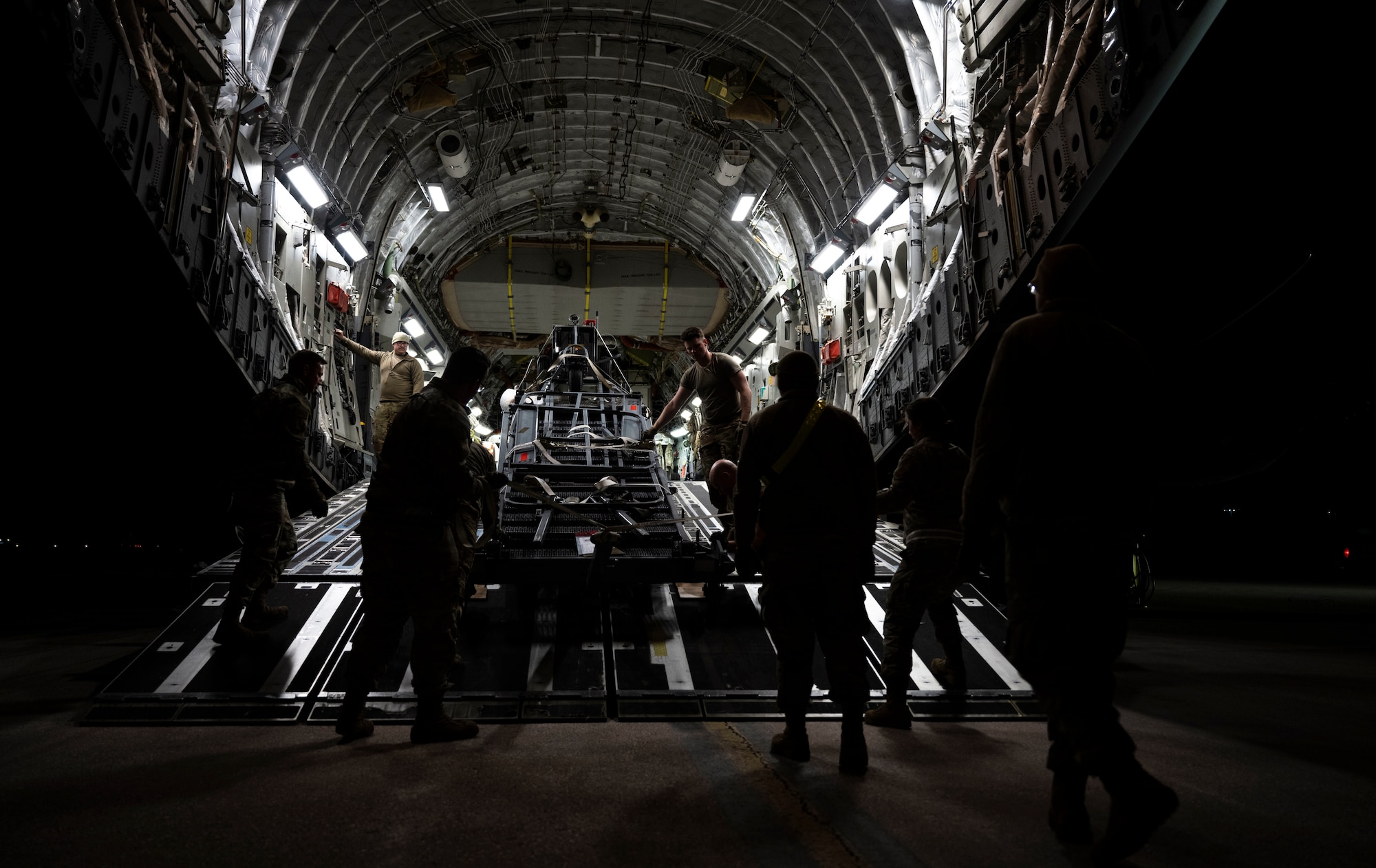 U.S. Airmen, assigned to the 28th Bomb Wing and the 15th Wing, load cargo onto a C-17  Globemaster III at Ellsworth Air Force Base, South Dakota during a partner integration mission in support of Exercise COPE INDIA 23, April 6, 2023. U.S. Indo-Pacific Command is committed to a free and open Indo-Pacific. (U.S. Air Force Photo by Airman 1st Class Yendi Borjas)