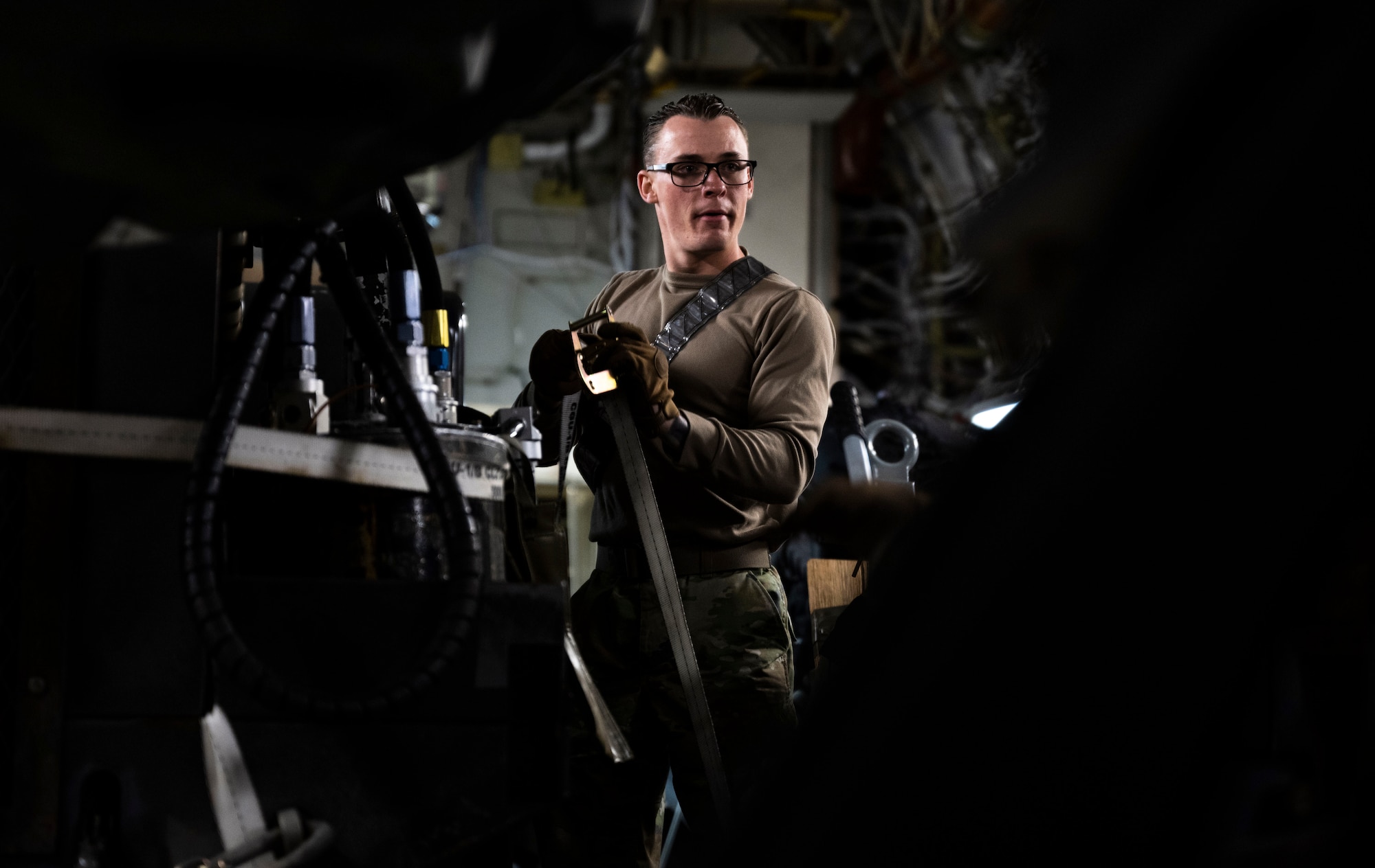 U.S. Air Force Senior Airman Rusty Thompson, 28th Logistic Readiness Squadron air transportation technician, secures cargo onto a C-17  Globemaster III at Ellsworth Air Force Base,  South Dakota during a partner integration mission in support of Exercise COPE INDIA 23, April 6, 2023. The Department of Defense and India have strengthened their defense and security partnership considerably, advancing regional security, military-to-military and information sharing cooperation. (U.S. Air Force Photo by Airman 1st Class Yendi Borjas)