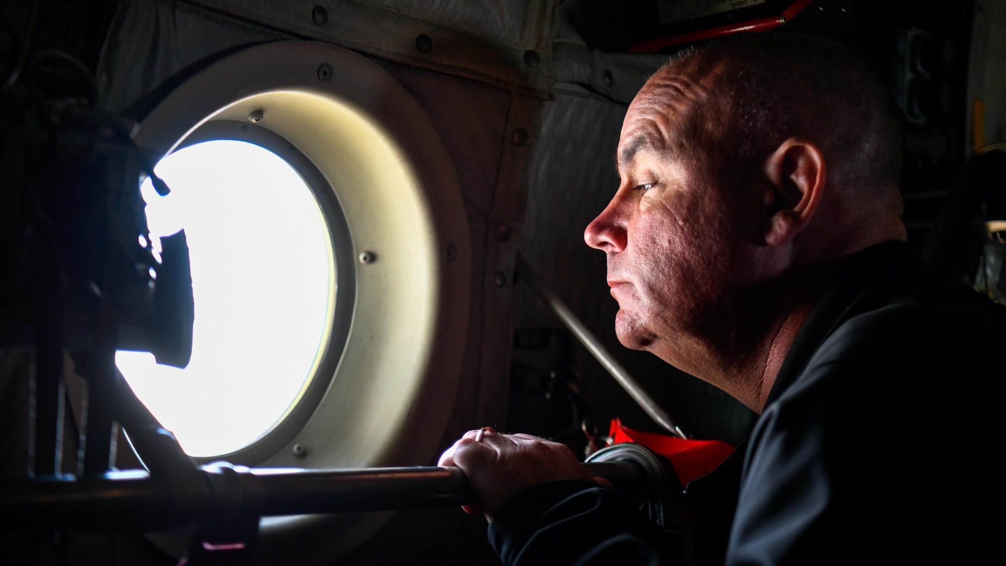 A local educator from the Youngstown Air Reserve Station recruitment area looks out the window of a C-130H Hercules aircraft assigned to the 910th Airlift Wing en route to Niagara Falls, April 27, 2023.