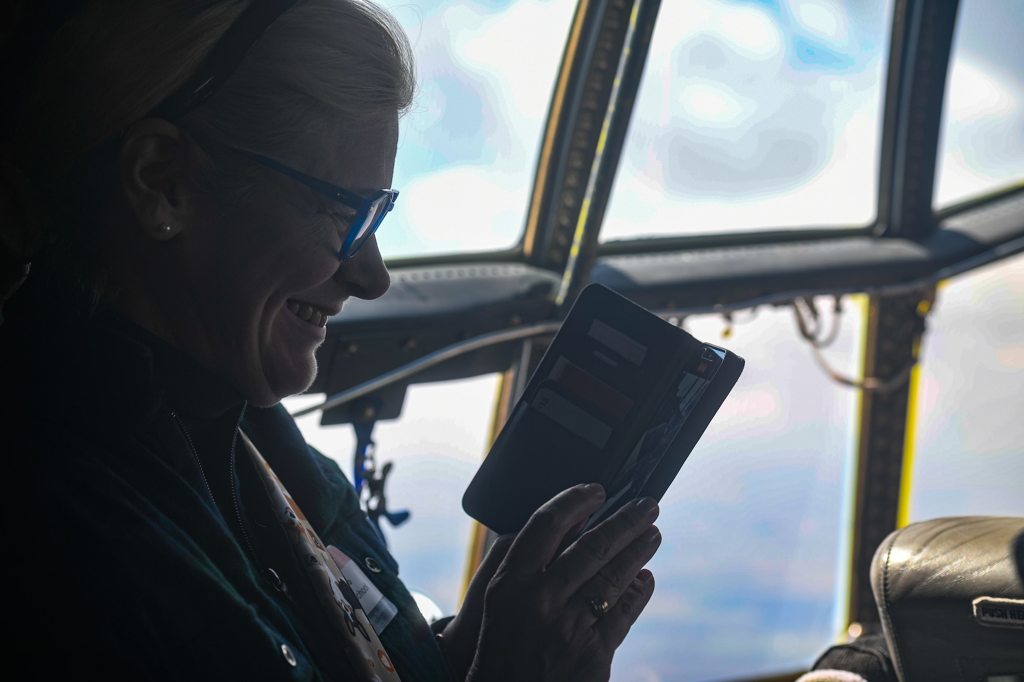 A local educator from the Youngstown Air Reserve Station recruitment area records a video on the flight deck of a C-130H Hercules aircraft assigned to the 910th Airlift Wing en route to Niagara Falls, April 27, 2023.