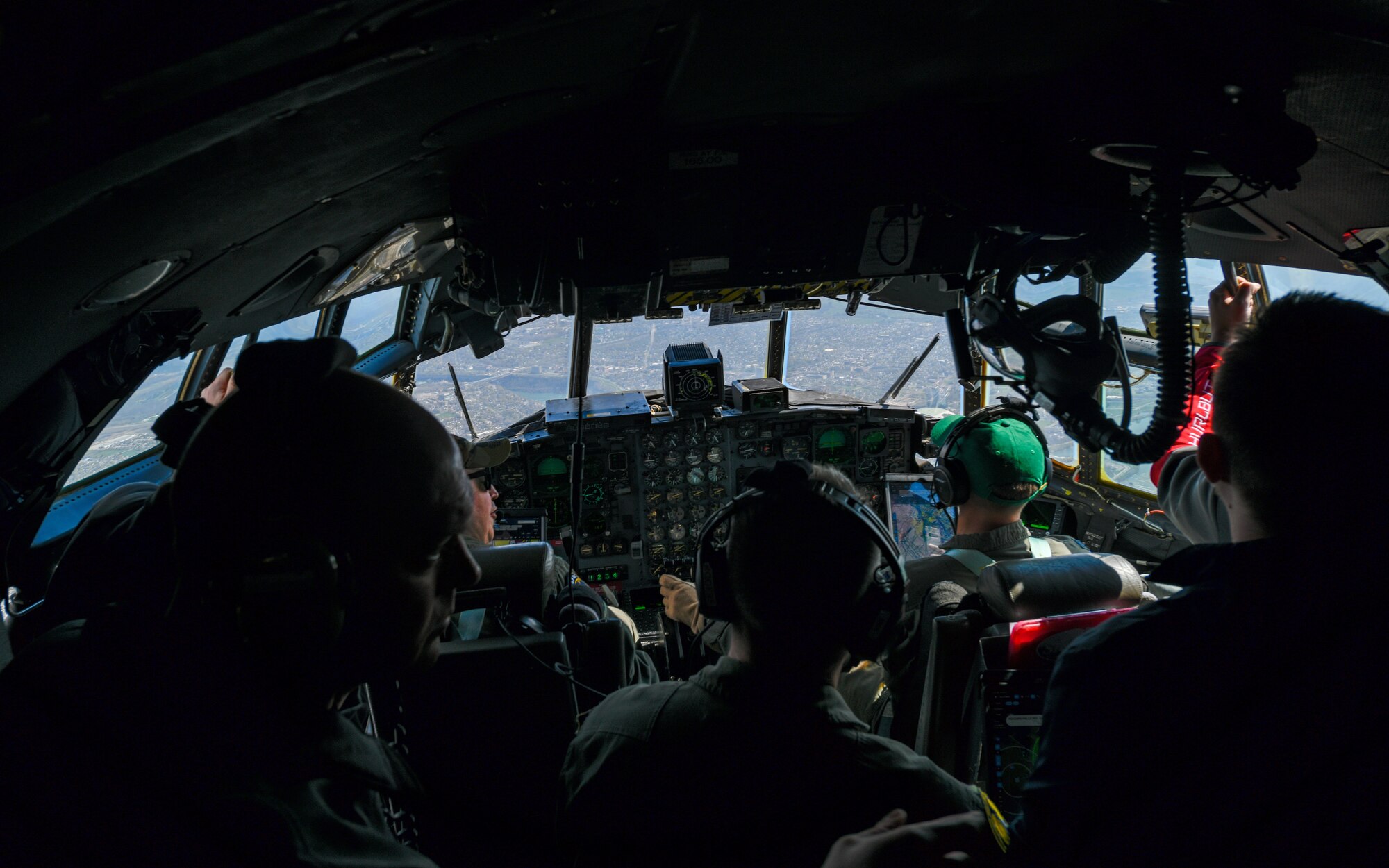 Local educators from the Youngstown Air Reserve Station recruitment area look out the flight deck windows of a C-130H Hercules aircraft assigned to the 910th Airlift Wing while circling above Niagara Falls, April 27, 2023.