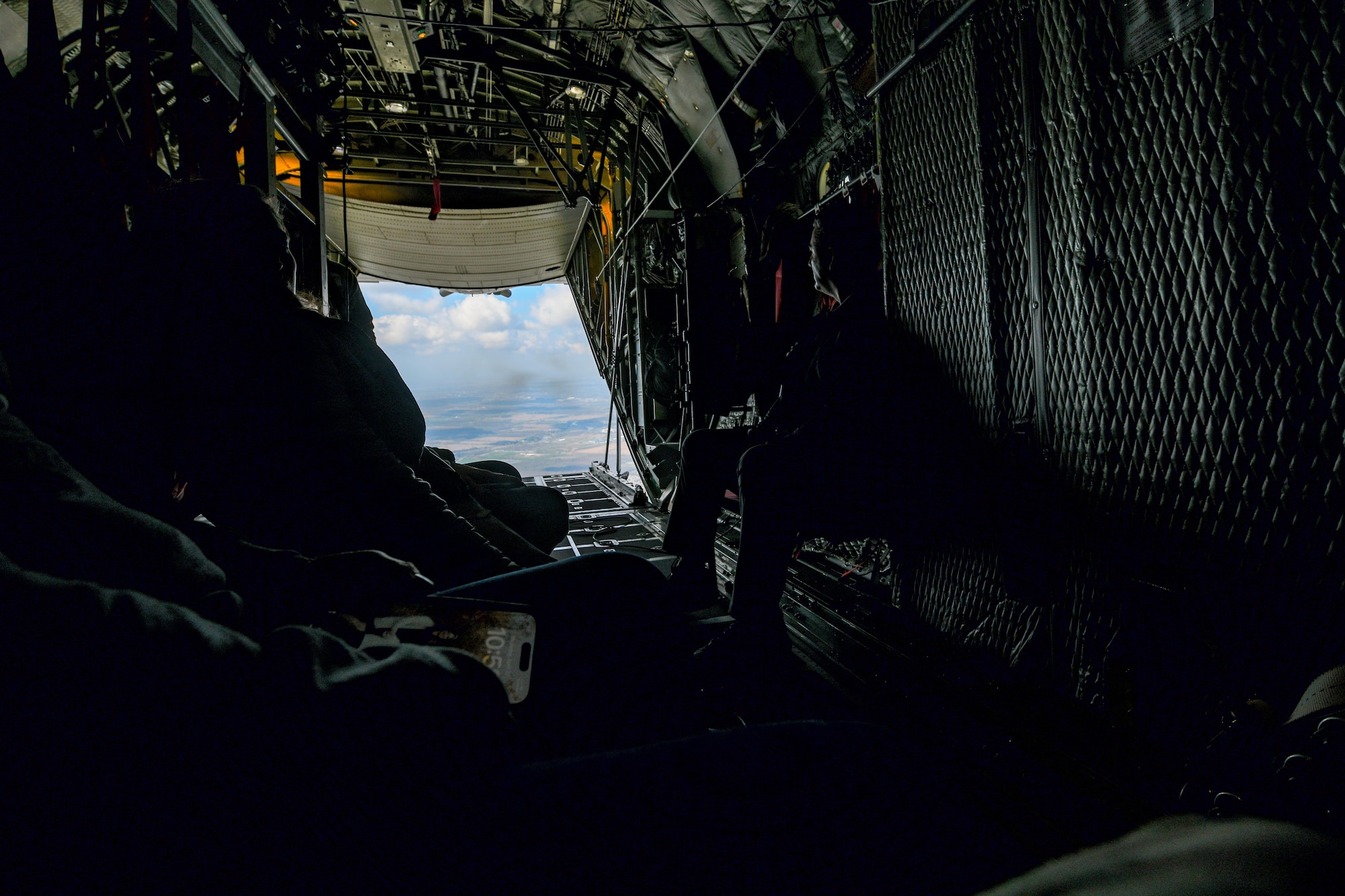 Local educators from the Youngstown Air Reserve Station recruitment area look out the back of a C-130H Hercules aircraft assigned to the 910th Airlift Wing while circling above Niagara Falls, April 27, 2023.