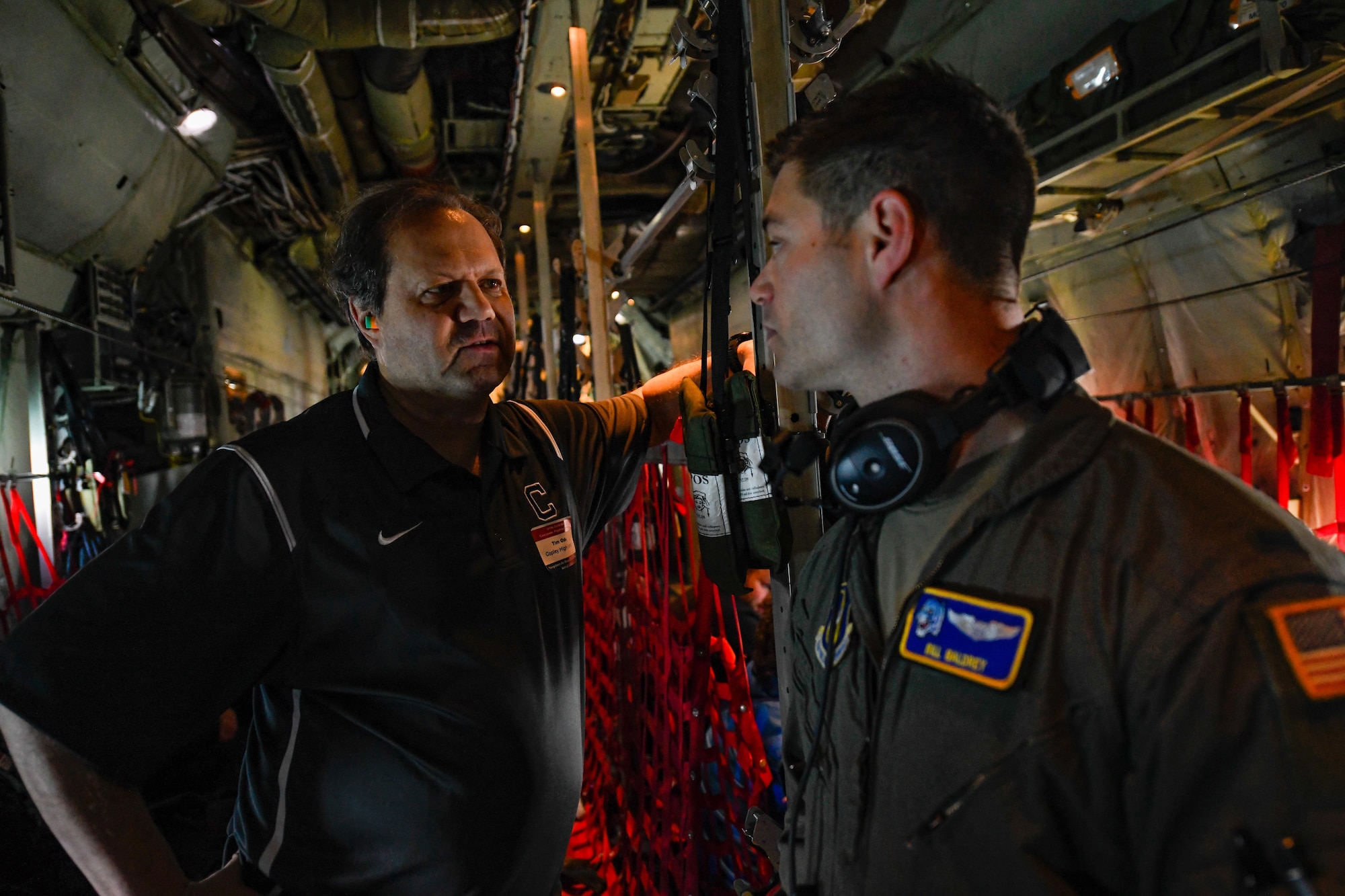 Tim Oden, a counselor at Copley High School, talks with 1st Lt. Bill Baldrey, a pilot assigned to the 757th Airlift Squadron, on a C-130H Hercules aircraft assigned to the 910th Airlift Wing on course back to Youngstown Air Reserve Station after circling Niagara Falls, April 27, 2023.