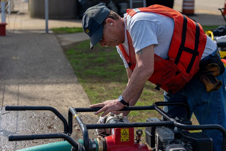 A man powers up a portable generator.