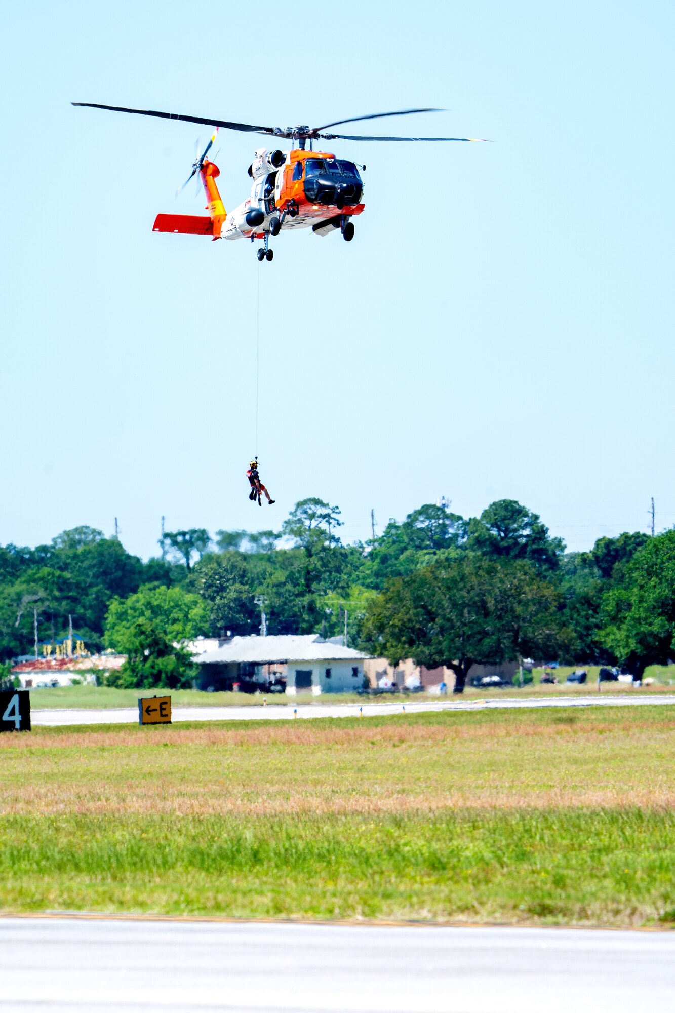 A U.S. Coast Guard HH-65 Helicopter hovers above the flightline during the 2023 Thunder Over the Sound Air and Space Show at Keesler Air Force Base, Mississippi, April 30, 2023.