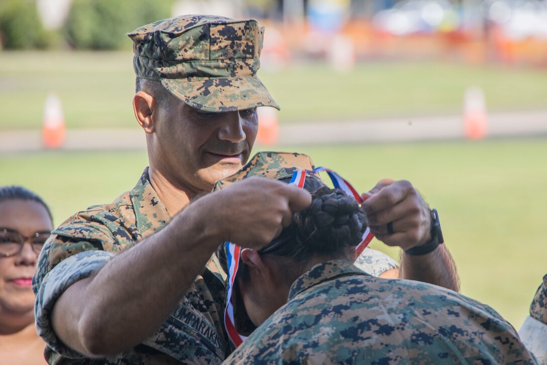 U.S. Marine Corps Col. Speros Koumparakis, the commanding officer of Marine Corps Base Hawaii (MCBH), presents a President’s Volunteer Service Award during a volunteer recognition and appreciation ceremony at MCBH, April 21, 2023. The ceremony recognized and honored individuals who demonstrated a sustained commitment to volunteer service over the course of 12 months. (U.S. Marine Corps photo by Sgt. Julian Elliott-Drouin)