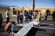 Guests visit a U.S. Army unmanned aerial vehicle display during Experience PTA Day at Army Garrison Pohakuloa Training Area, Hawaii, April 20, 2023. Experience PTA Day was a community engagement event focused on showcasing PTA and its importance as a training center for U.S. armed forces in the Pacific. (U.S. Marine Corps photo by Lance Cpl. Clayton Baker)