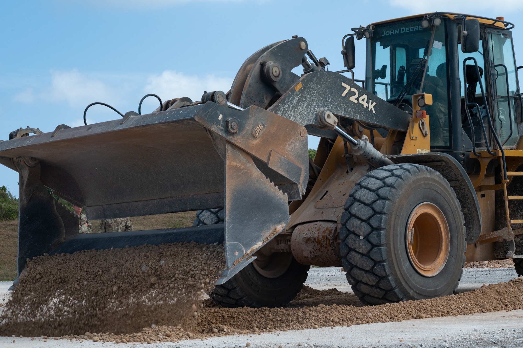 An Airman assigned to the 36th Civil Engineer Squadron uses a loader to move debris during an expedient and expeditionary airfield damage repair demonstration hosted by Headquarters Pacific Air Forces Civil Engineer Division at the Pacific Regional Training Center-Andersen, Guam, April 20, 2023. Sixteen Airmen from the 36th CES were provided two days of vehicle and material familiarization from the 554th Rapid Engineer Deployable Heavy Operational Repair Squadron Engineers and the Air Force Civil Engineer Center to complete airfield damage repair using the smaller packages of Airmen and equipment, called E-ADR. They used their familiarization to validate the E-ADR concept, in support of a Pacific Air Forces agile combat employment initiative, repairing 10 craters with a lighter and leaner vehicle and equipment kit that weighs a fraction of a standard Rapid Airfield Damage Recovery package. (U.S. Air Force photo by Staff Sgt. Suzie Plotnikov)