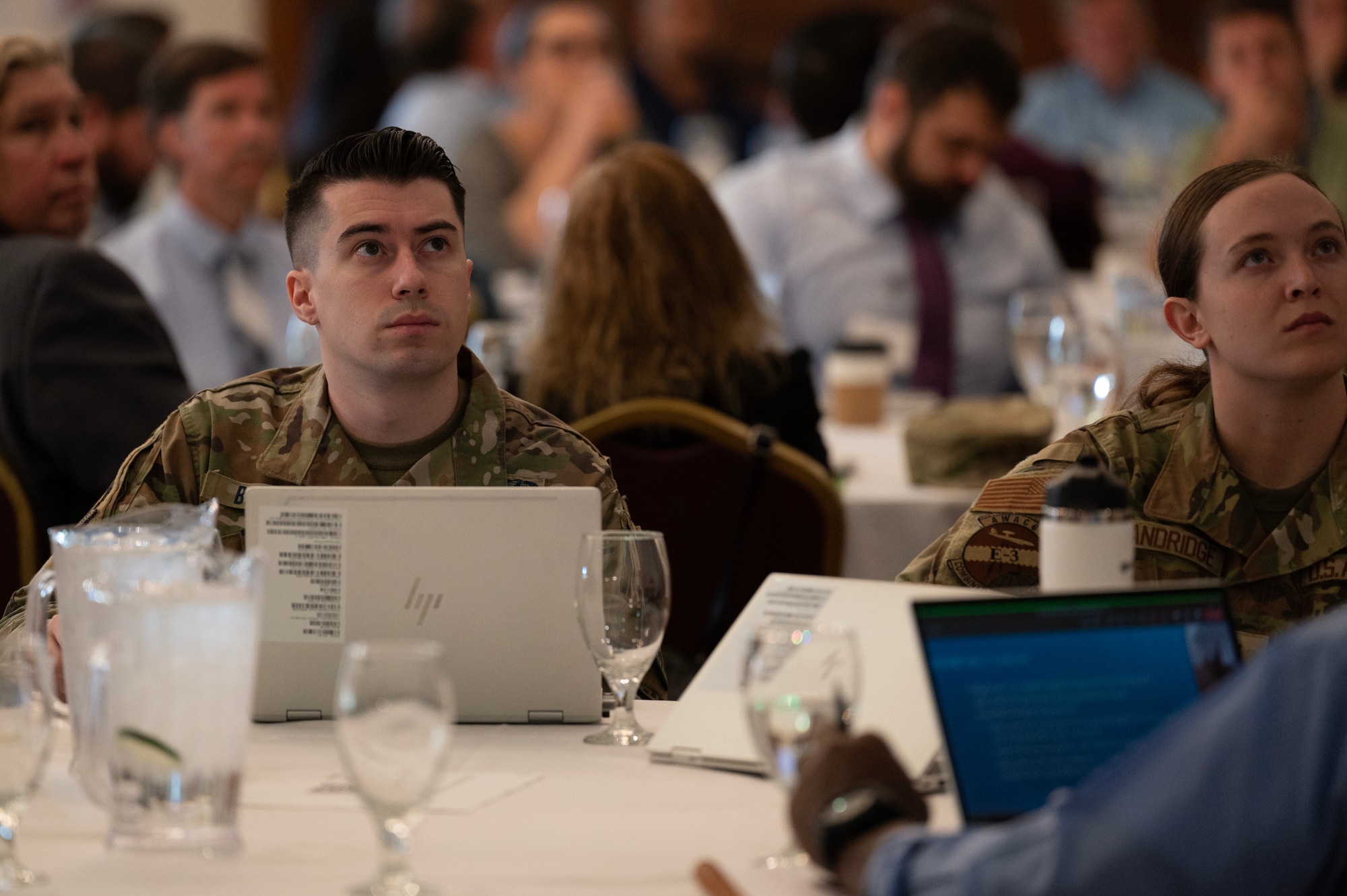 Military man listens to a presentation at a digital engineering workshop