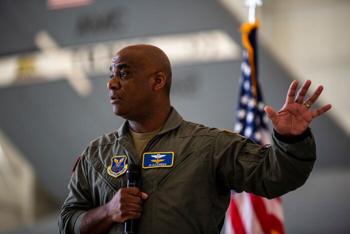A man speaks at a microphone.