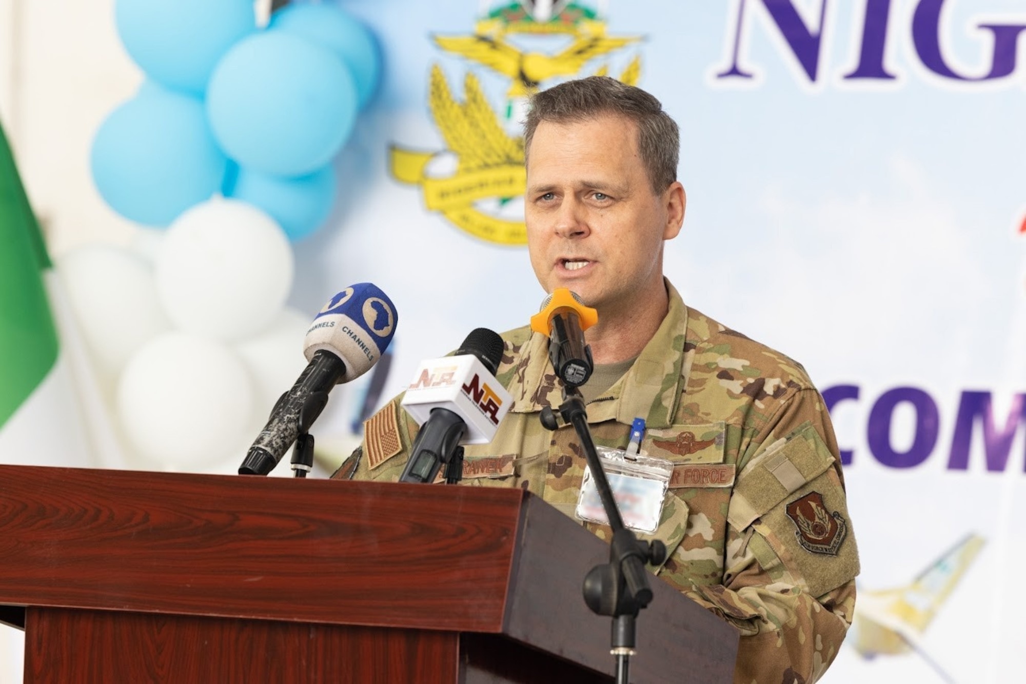 Director of the Air Force Life Cycle Management Center's Air Force Security Assistance and Cooperation Directorate Brig. Gen. Joel Safranek gives remarks at Kainji Air Force Base in Nigeria during ceremonies celebrating recently completed base infrastructure improvements there April 27, 2023. He participated in ribbon cutting ceremonies highlighting the completion of several construction projects supporting recently delivered A-29 Super Tucano aircraft. The construction was part of the historic $500 million U.S. foreign military sale to Nigeria, which also includes the delivery of the 12 A-29 Super Tucano aircraft, munitions, and training. (U.S. Embassy in Nigeria photo by Olaoluwa Aworinde)