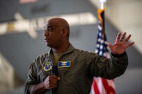 A man speaks at a microphone.