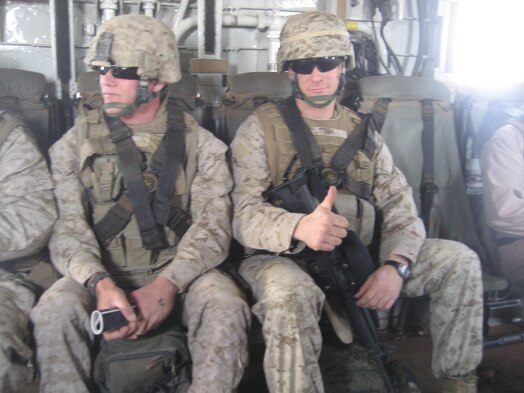  Two men in military uniforms sitting on the inside of military aircraft