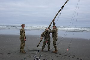 Setting up communication equipment on an Oregon beach