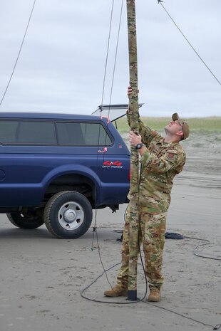 Setting up communication equipment on an Oregon beach