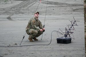 Setting up communication equipment on an Oregon beach