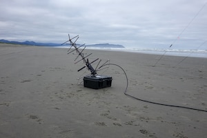 Setting up communication equipment on an Oregon beach