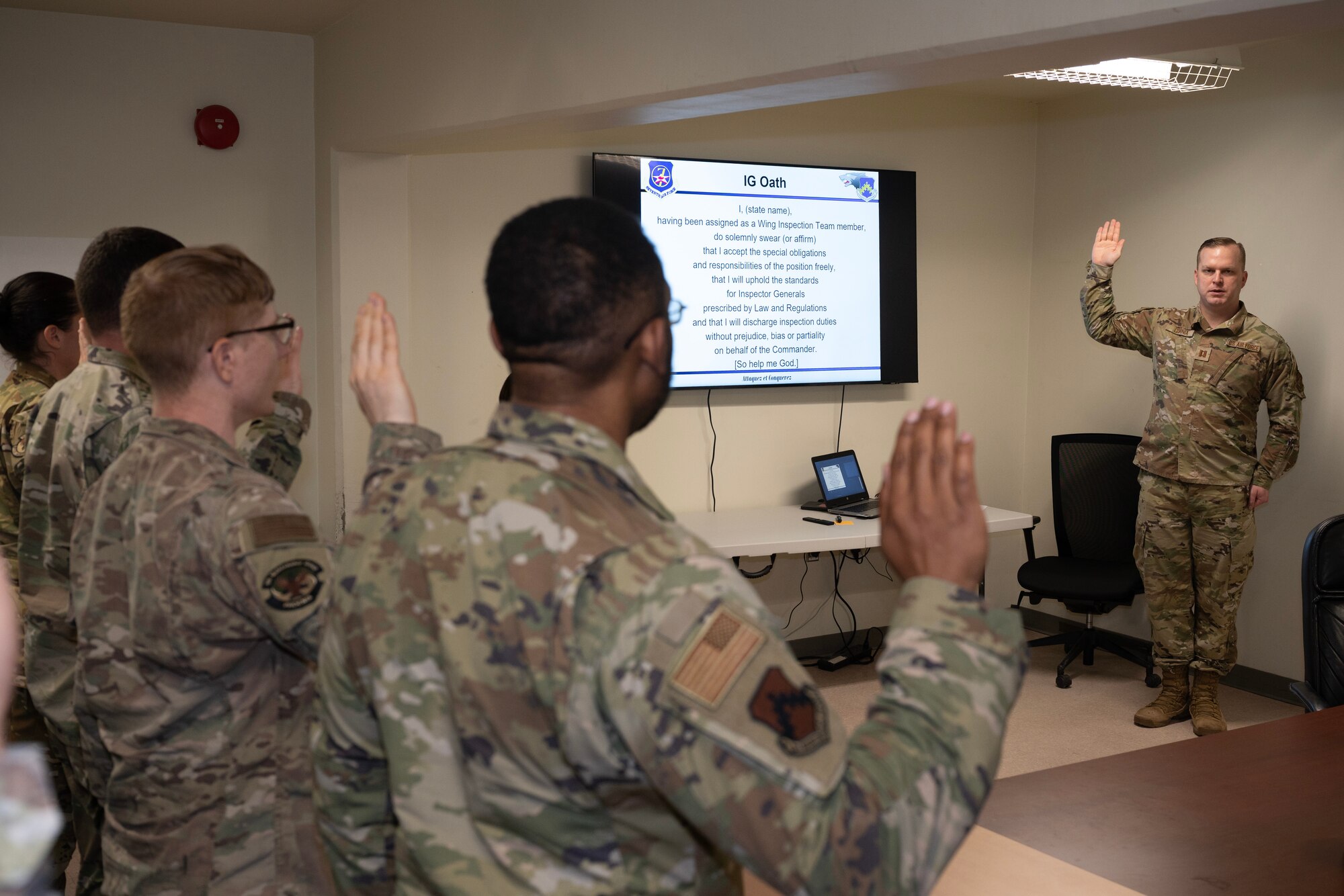 5 individuals raise their right hands and recite an oath