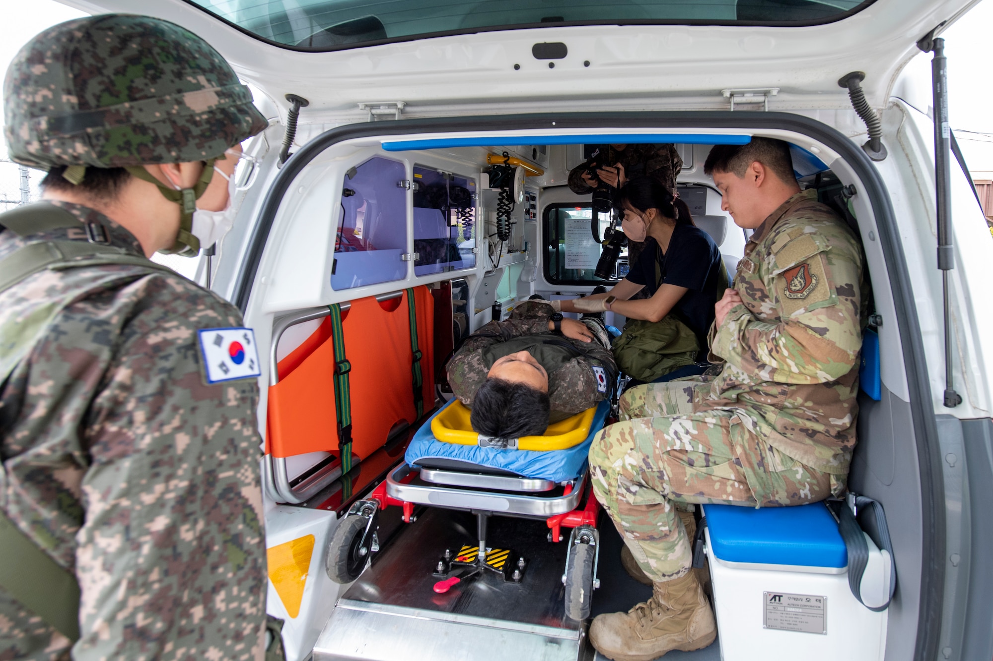 Republic of Korea Air Force medical personnel load simulated victims into the back of an ambulance during an active shooter training event at Daegu Air Base, ROK, April 24, 2023. During the training, U.S. Air Force members partnered with ROKAF personnel to test capabilities on response and communication, ensuring they have the most efficient airtight operation possible during an active shooter response. (U.S. Air Force photo by Airman 1st Class Aaron Edwards)